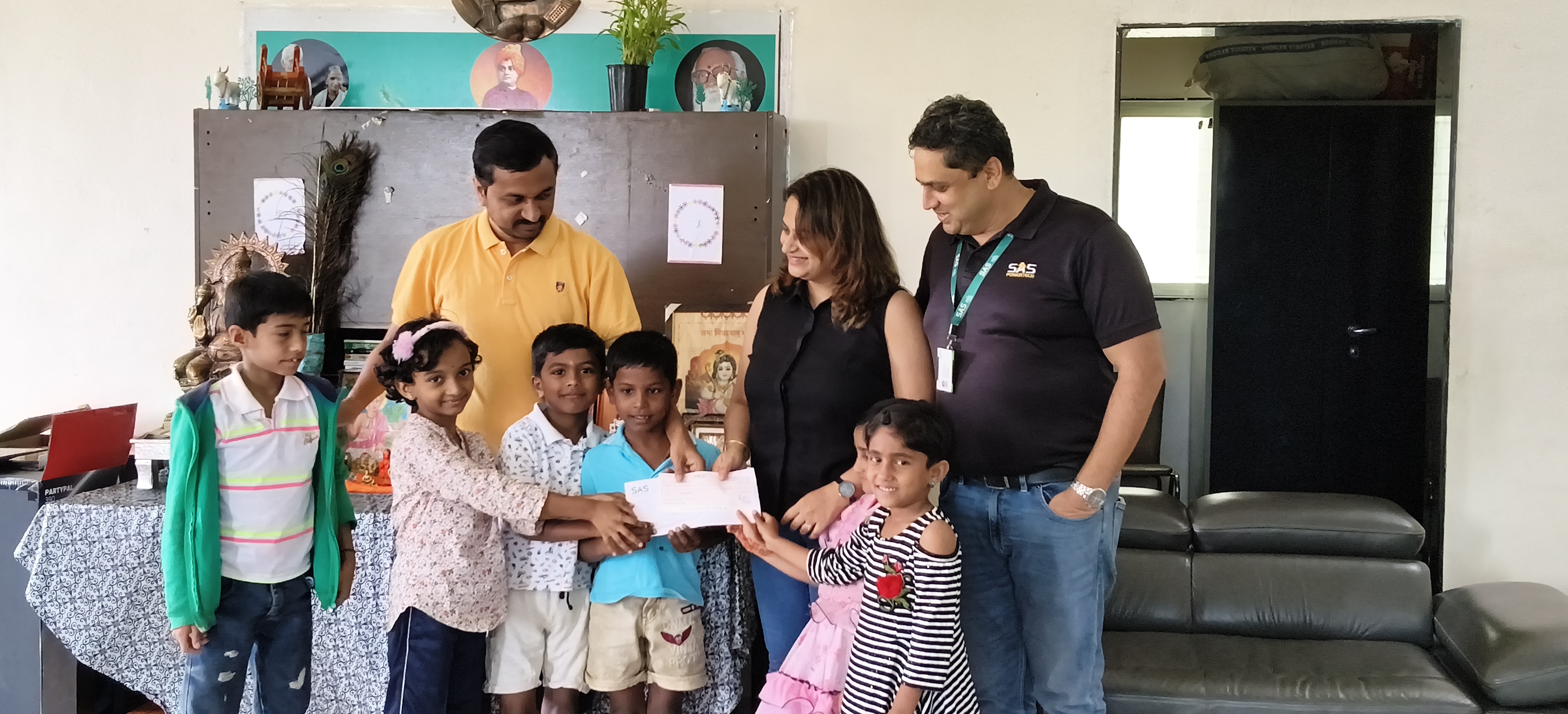 SAS Powertech leadership formally presenting contribution cheque at the institution